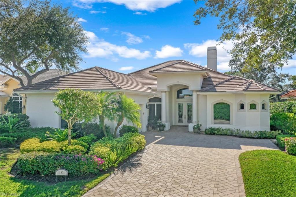 183 Audubon Boulevard Naples, FL 34110 - Photo 2 of 35 a front view of a house with garden