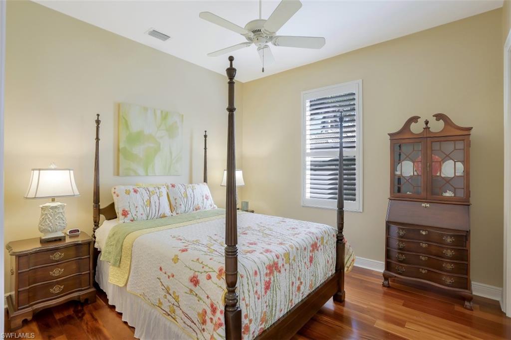 183 Audubon Boulevard Naples, FL 34110 - Photo 25 of 35 a bedroom with a bed and wooden floor