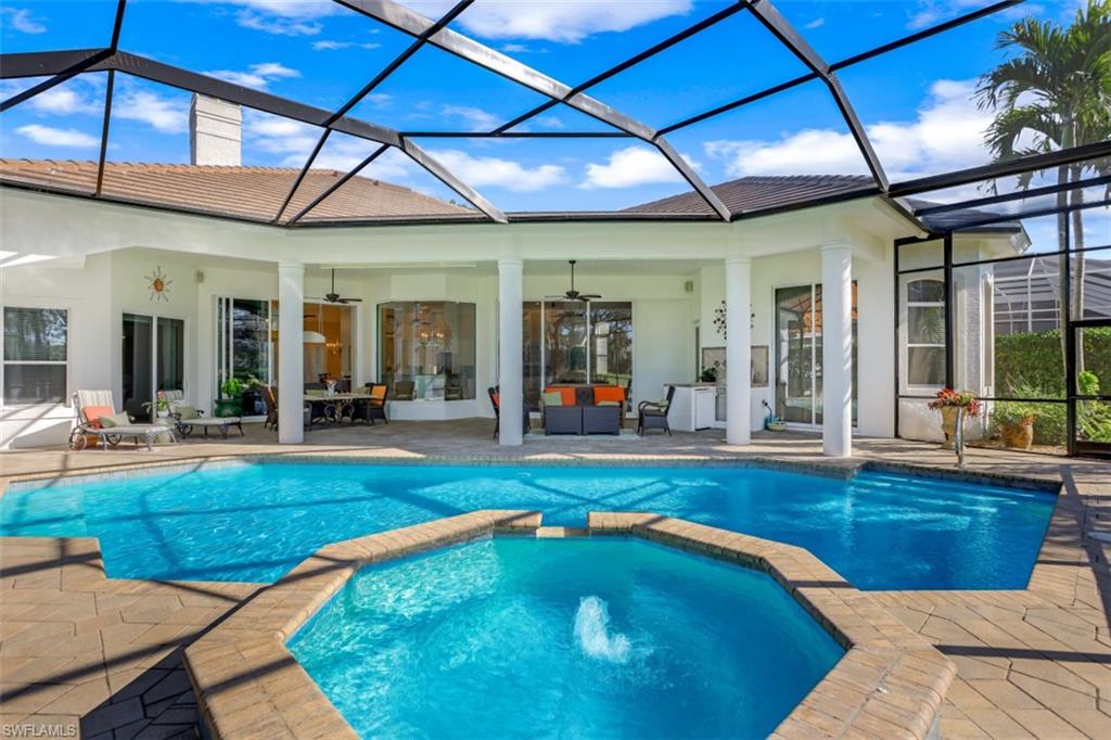 183 Audubon Boulevard Naples, FL 34110 - Photo 5 of 35 a view of a swimming pool with sitting area