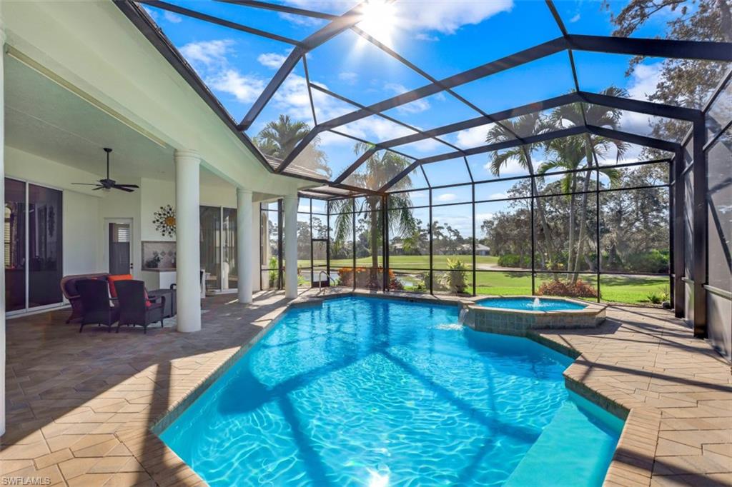183 Audubon Boulevard Naples, FL 34110 - Photo 8 of 35 a swimming pool with garden view