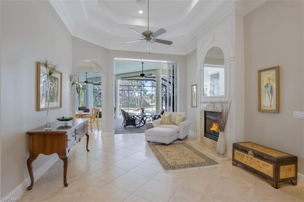 183 Audubon Boulevard Naples, FL 34110 - Photo 9 of 35 a living room with furniture fireplace and a large window