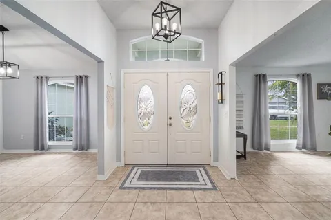 a living room with furniture and a ceiling fan