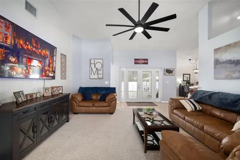 a living room with furniture a flat screen tv and a couch