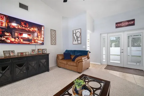 a living room with furniture and a chandelier