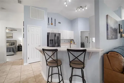 a kitchen with a refrigerator and cabinets