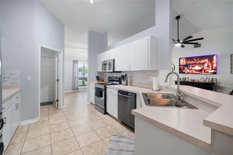 a kitchen with a sink stove and microwave