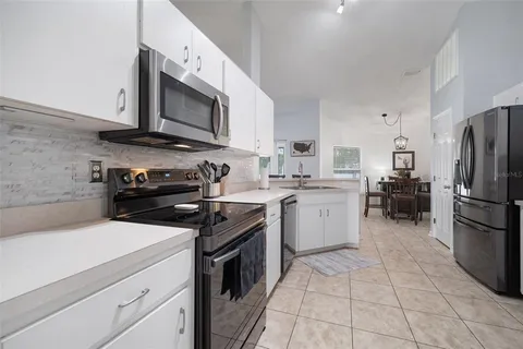 a spacious bedroom with a bed and a chandelier