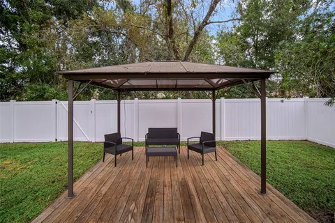 a view of backyard with sitting area