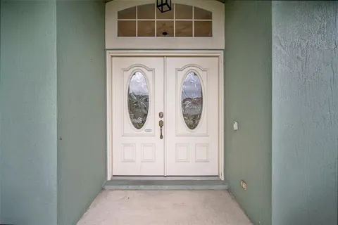 a living room with furniture a bed and a ceiling fan