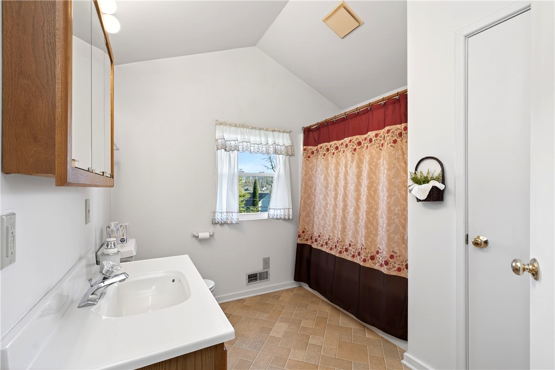 1237 Laurelwood Road Dayton, OH 45409 - Photo 29 of 56 This bright bathroom features vaulted ceilings and a window for natural light.