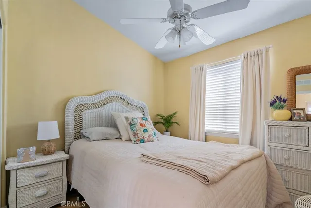 a bedroom with a bed and a painting on the wall