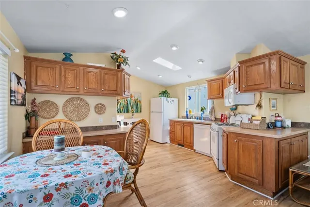a kitchen that has a lot of cabinets in it and wooden floors