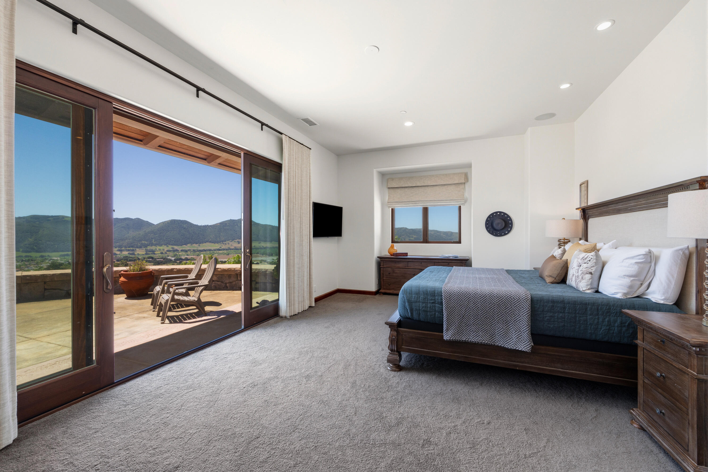 1418 Ribe Road Solvang, CA 93463 - Photo 19 of 46 a living room with a balcony bed and furniture next to a large window