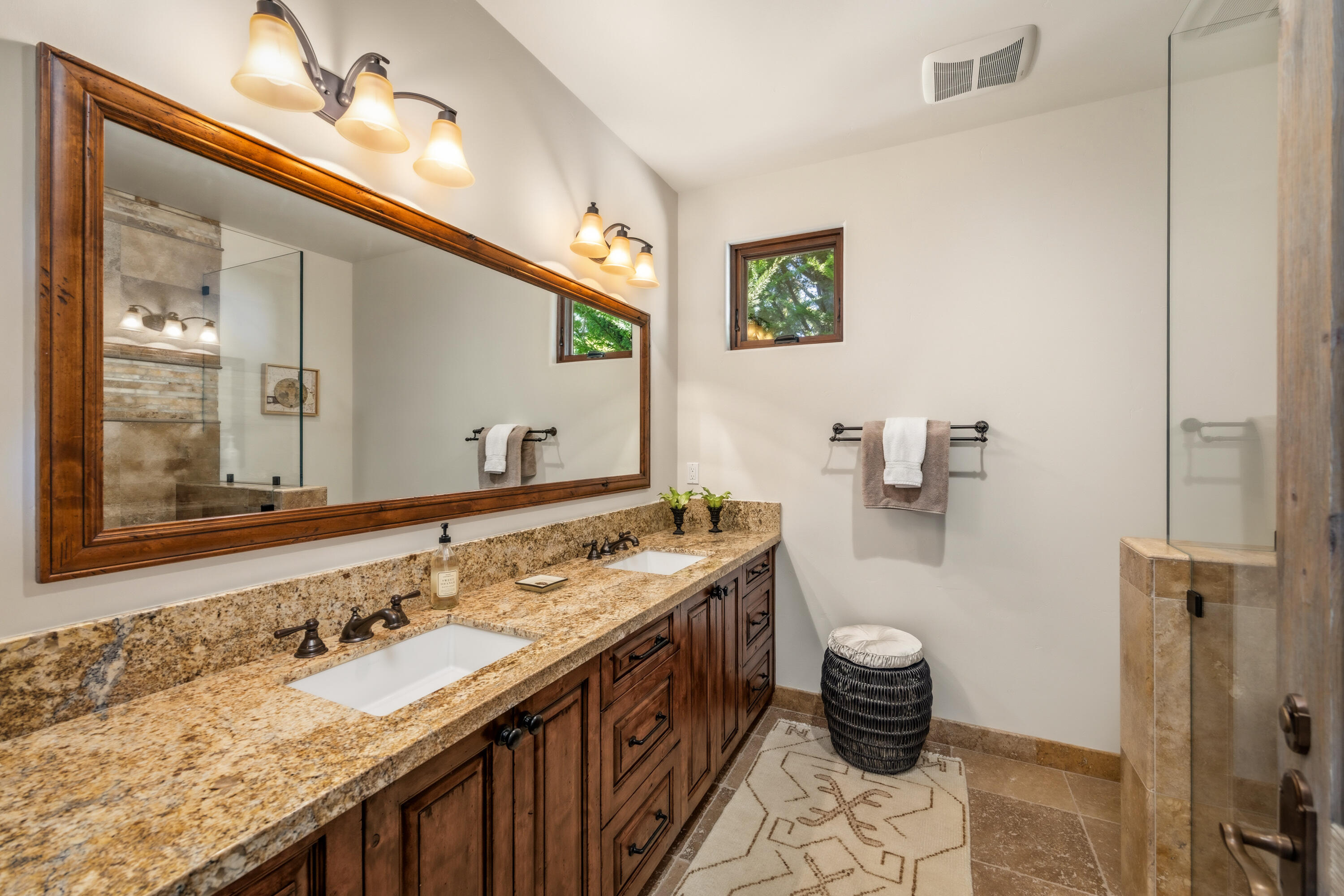 1418 Ribe Road Solvang, CA 93463 - Photo 24 of 46 a bathroom with a granite countertop sink a large mirror and a shower