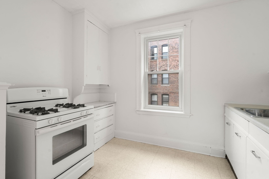 97 Chester Street, Unit 8 Boston, MA 02134 - Photo 9 of 19 a stove top oven sitting inside of a kitchen