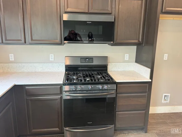 a stove top oven sitting inside of a kitchen