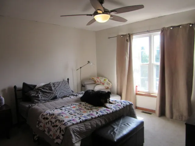 a view of a livingroom with furniture and a window