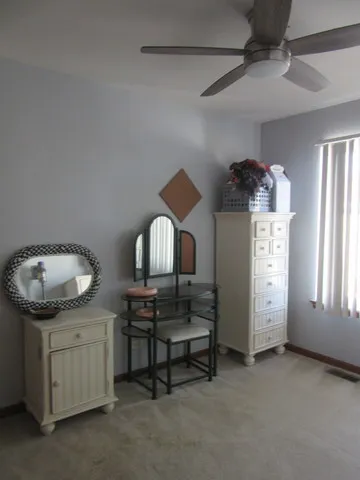 a bedroom with a bed and painting on the wall