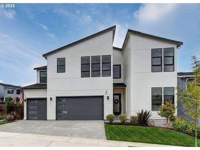 a front view of a house with a yard and garage