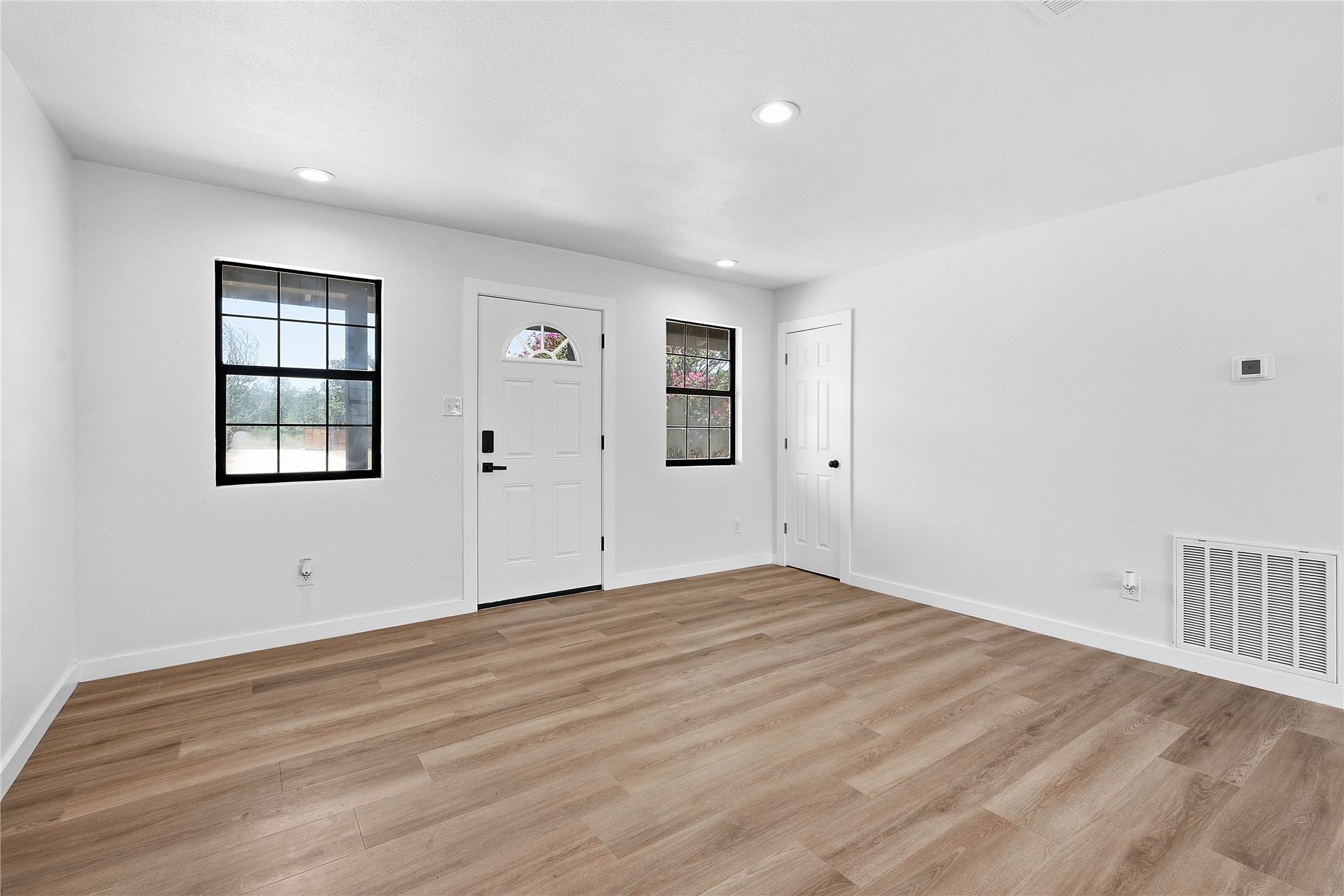 747 Chamberlin Road Dale, TX 78616 - Photo 5 of 28 A spacious room offers new vinyl plank flooring and recessed lighting.