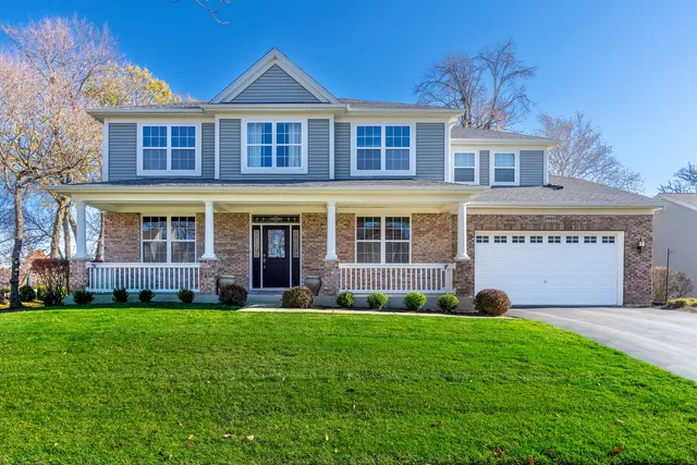 front view of a brick house with a yard