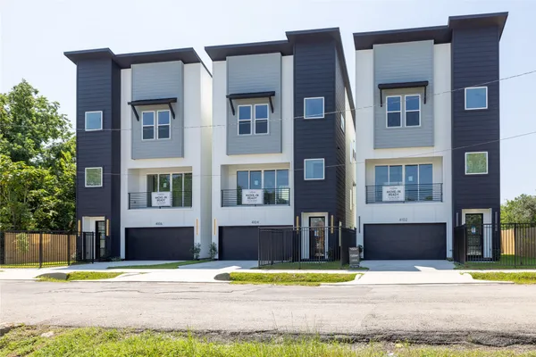a front view of a building with a yard