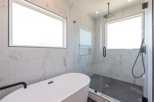a bathroom with a tub and a shower