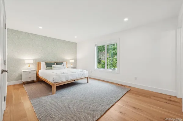 a bedroom with a bed and a night stand