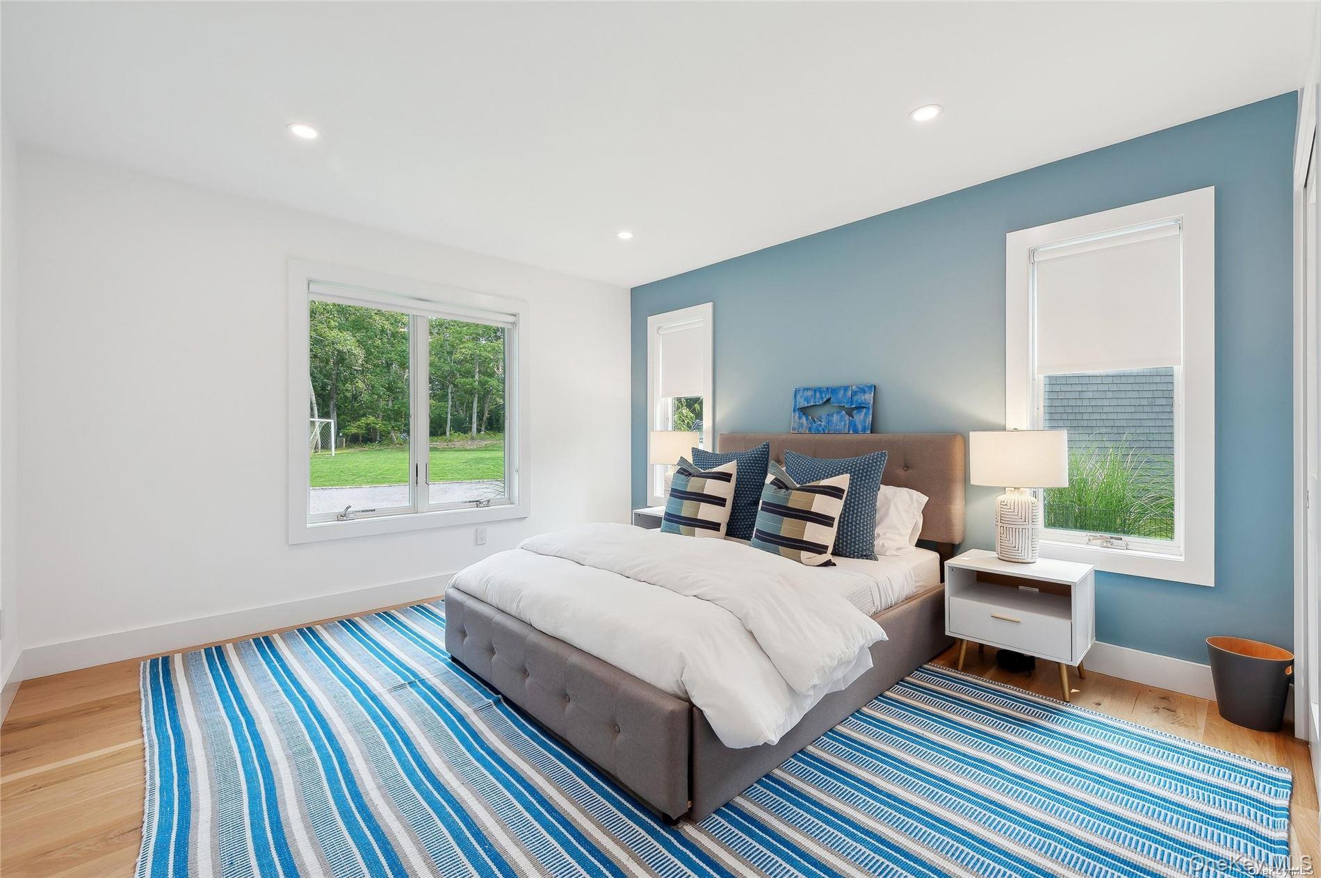 28 Old Meeting House Road Quogue, NY 11959 - Photo 16 of 34 a bedroom with a bed and wooden floor