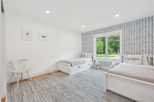 a spacious bedroom with a bed and a table