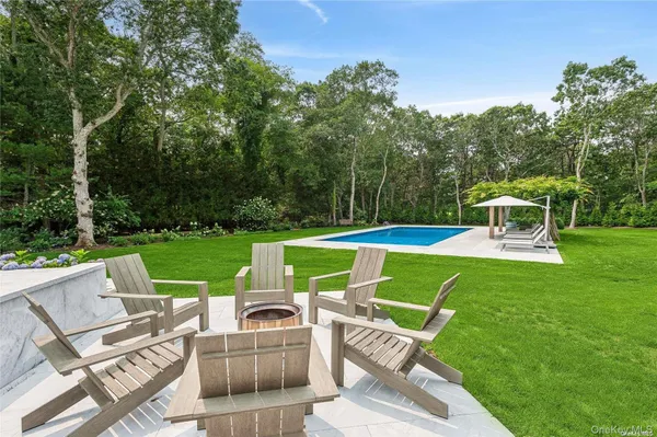 a view of a chairs and table in the yard
