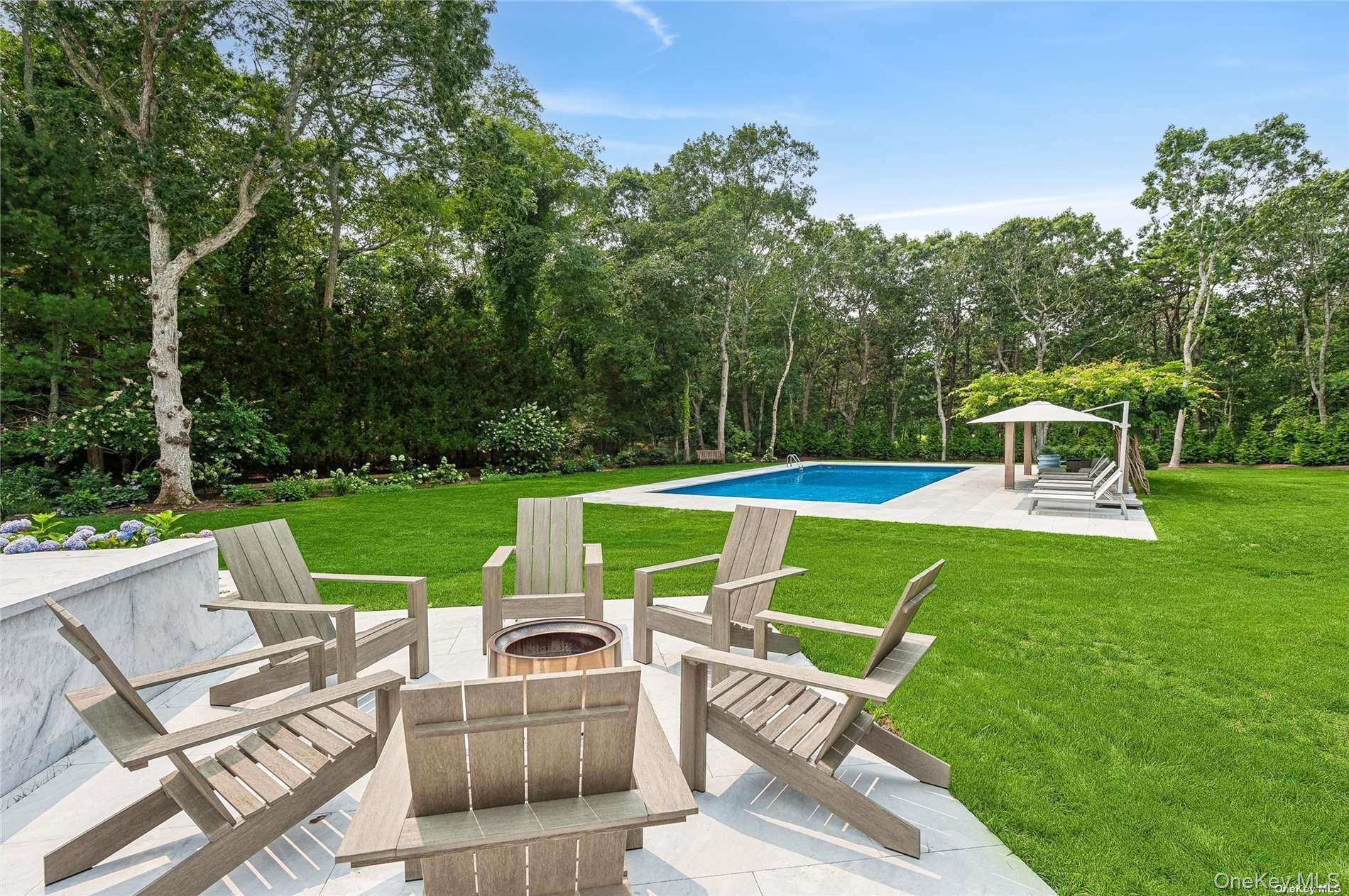 28 Old Meeting House Road Quogue, NY 11959 - Photo 25 of 34 a view of a chairs and table in the yard