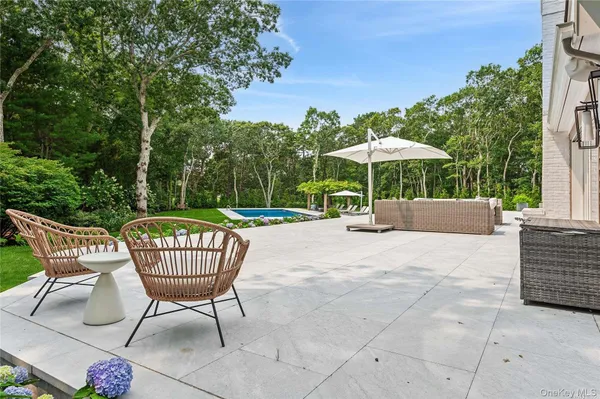 a view of a patio with a table and chairs