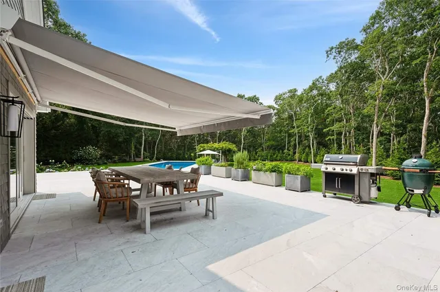a view of a patio with table and chairs potted plants with wooden fence
