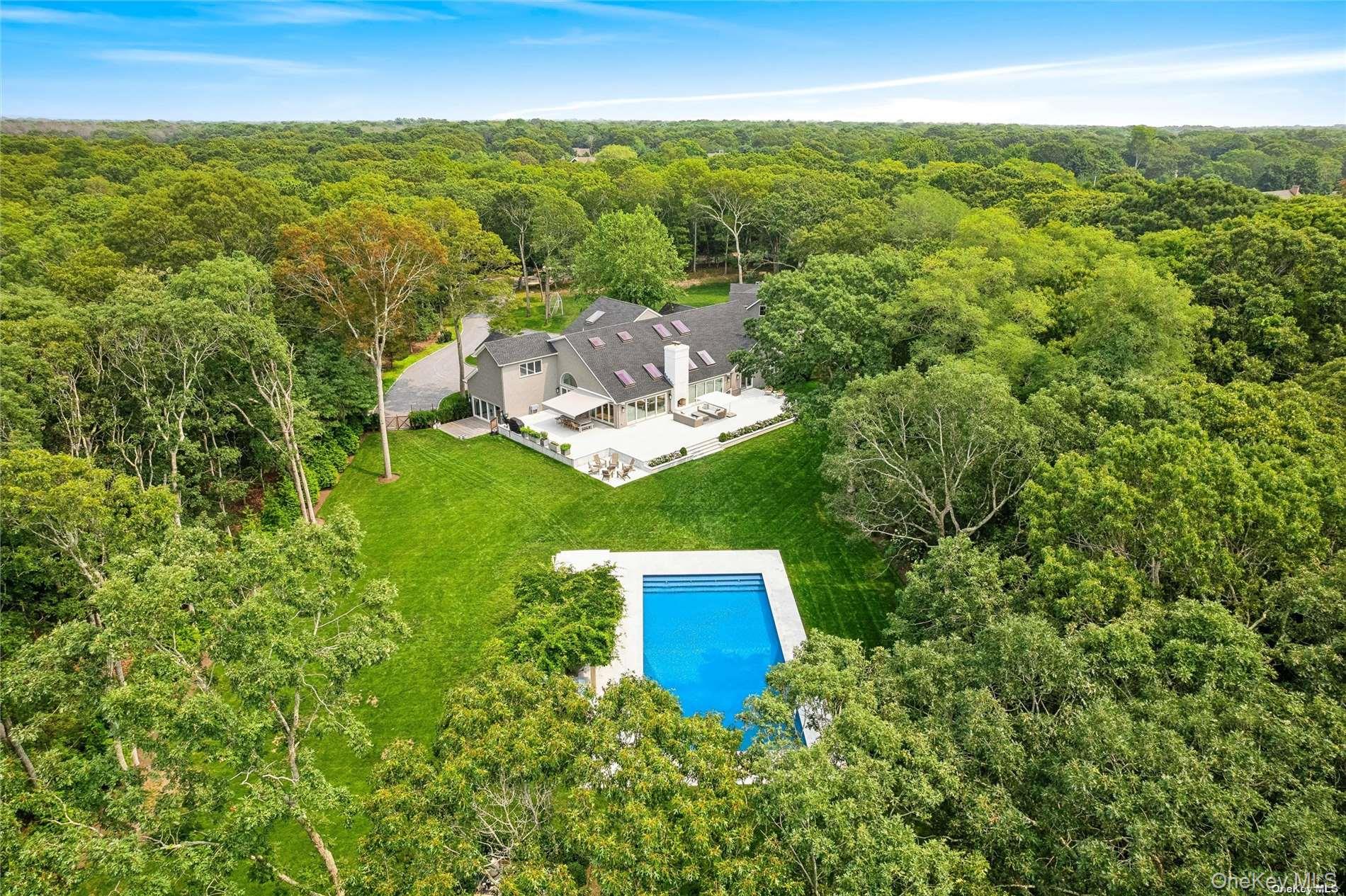 28 Old Meeting House Road Quogue, NY 11959 - Photo 3 of 34 a view of a city with lush green forest