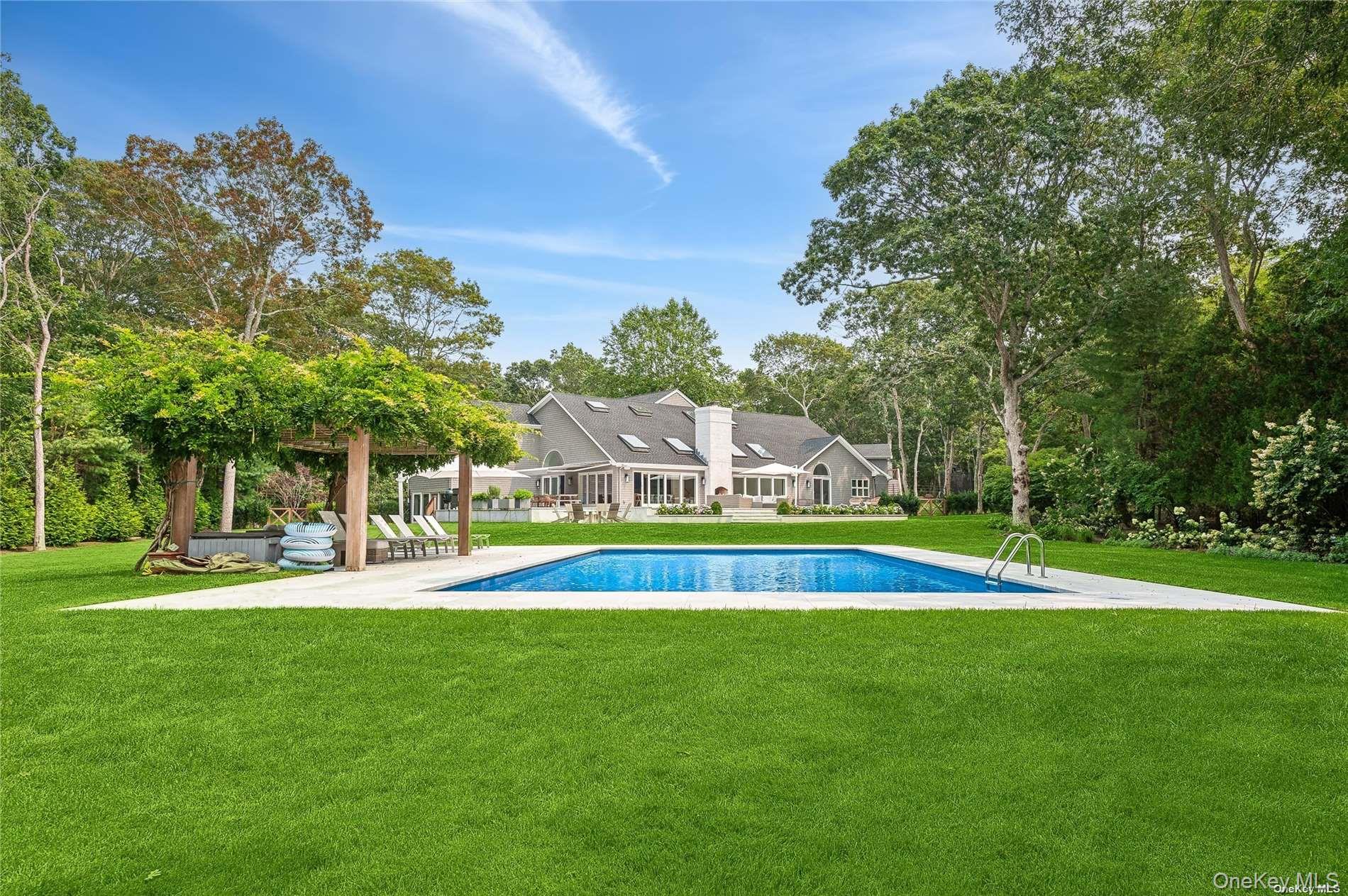 28 Old Meeting House Road Quogue, NY 11959 - Photo 4 of 34 a view of pool with garden and trees
