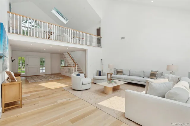 a living room with patio furniture and a dining table