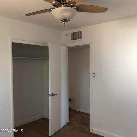 a view of a hallway with a wooden cabinets