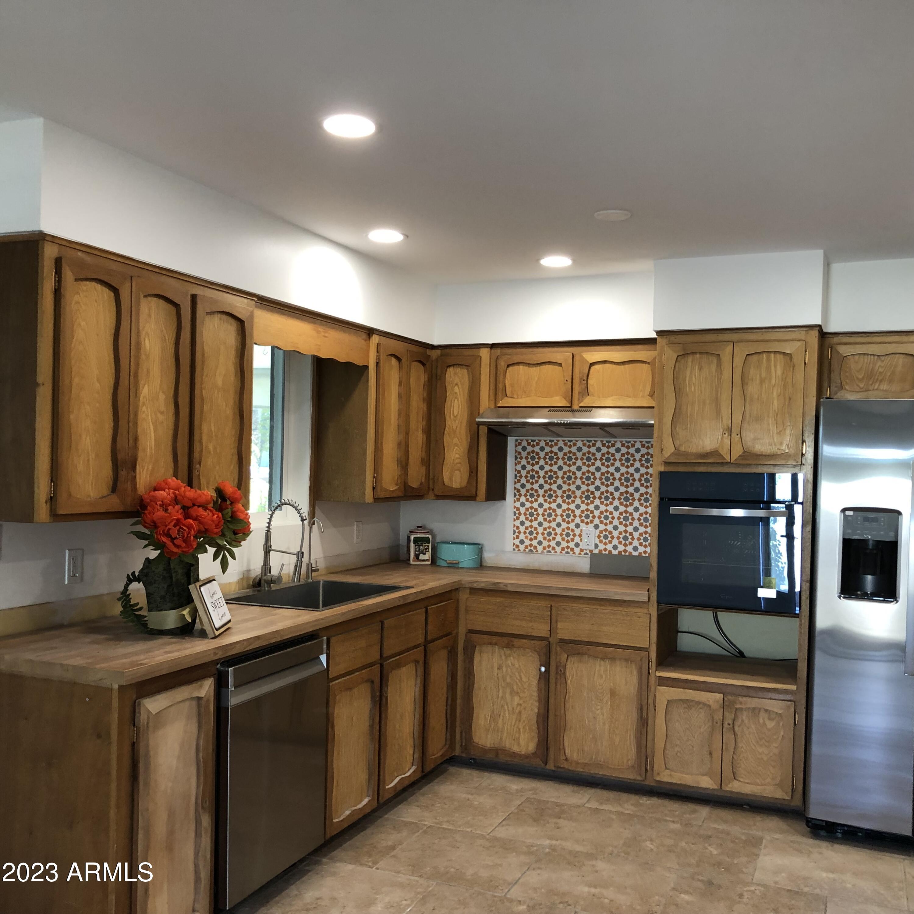 705 West 16th Street Tempe, AZ 85281 - Photo 18 of 24 a kitchen with stainless steel appliances a sink stove and cabinets