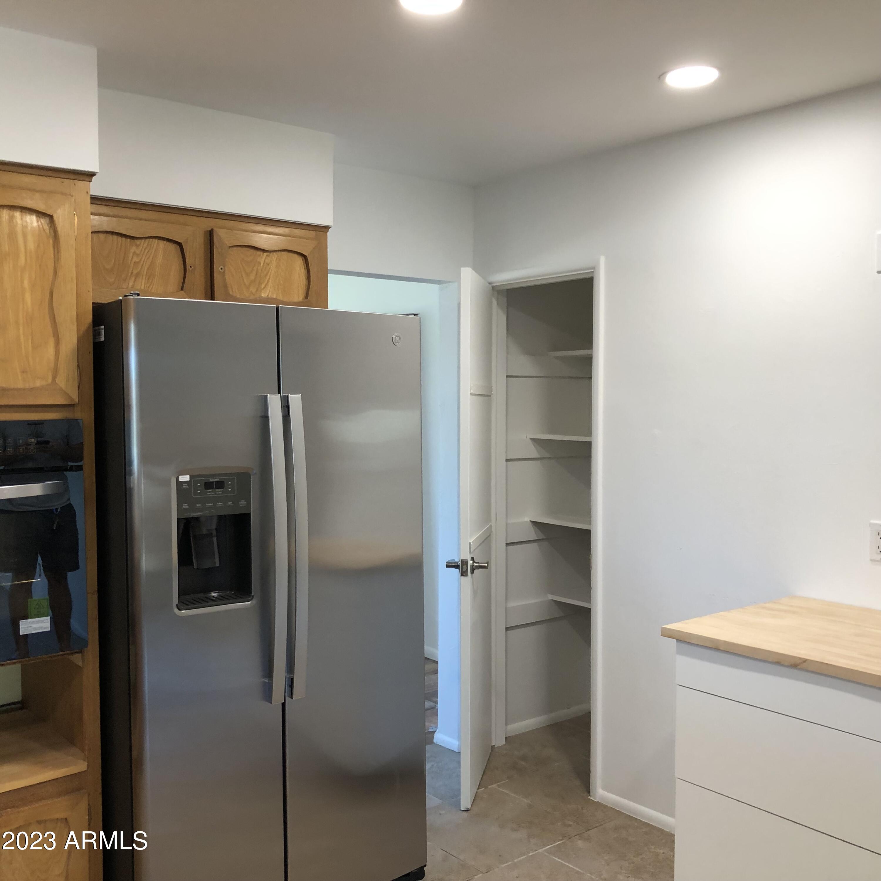 705 West 16th Street Tempe, AZ 85281 - Photo 20 of 24 a kitchen with a refrigerator and cabinets