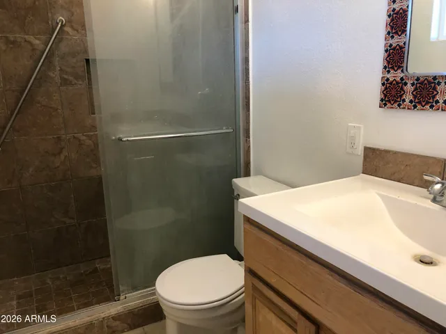 a view of a hallway with a wooden cabinets