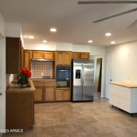 a kitchen with refrigerator and microwave