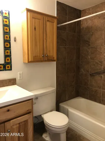 a living room with a couch and a ceiling fan