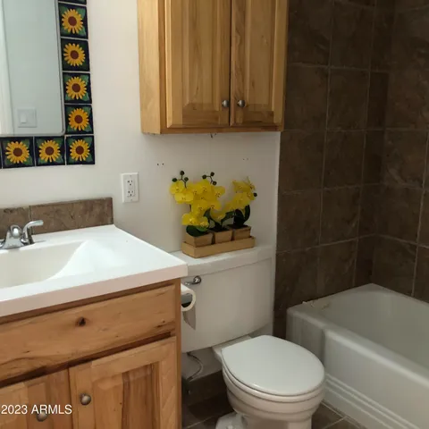 a bathroom with a sink a toilet and bathtub