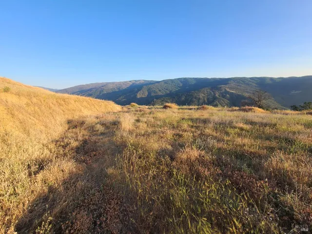 a view of mountain and an ocean