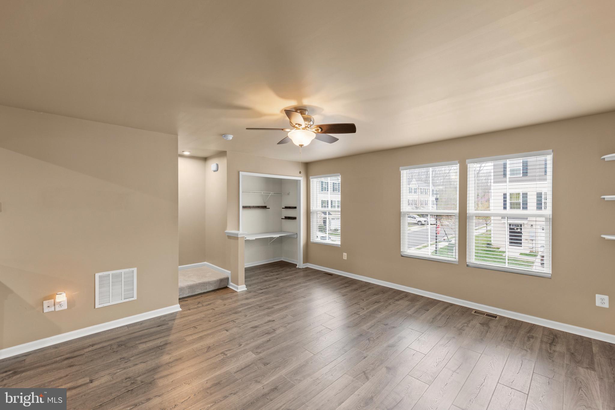 113 Reign Way Winchester, VA 22603 - Photo 12 of 35 a view of an empty room with a window and wooden floor