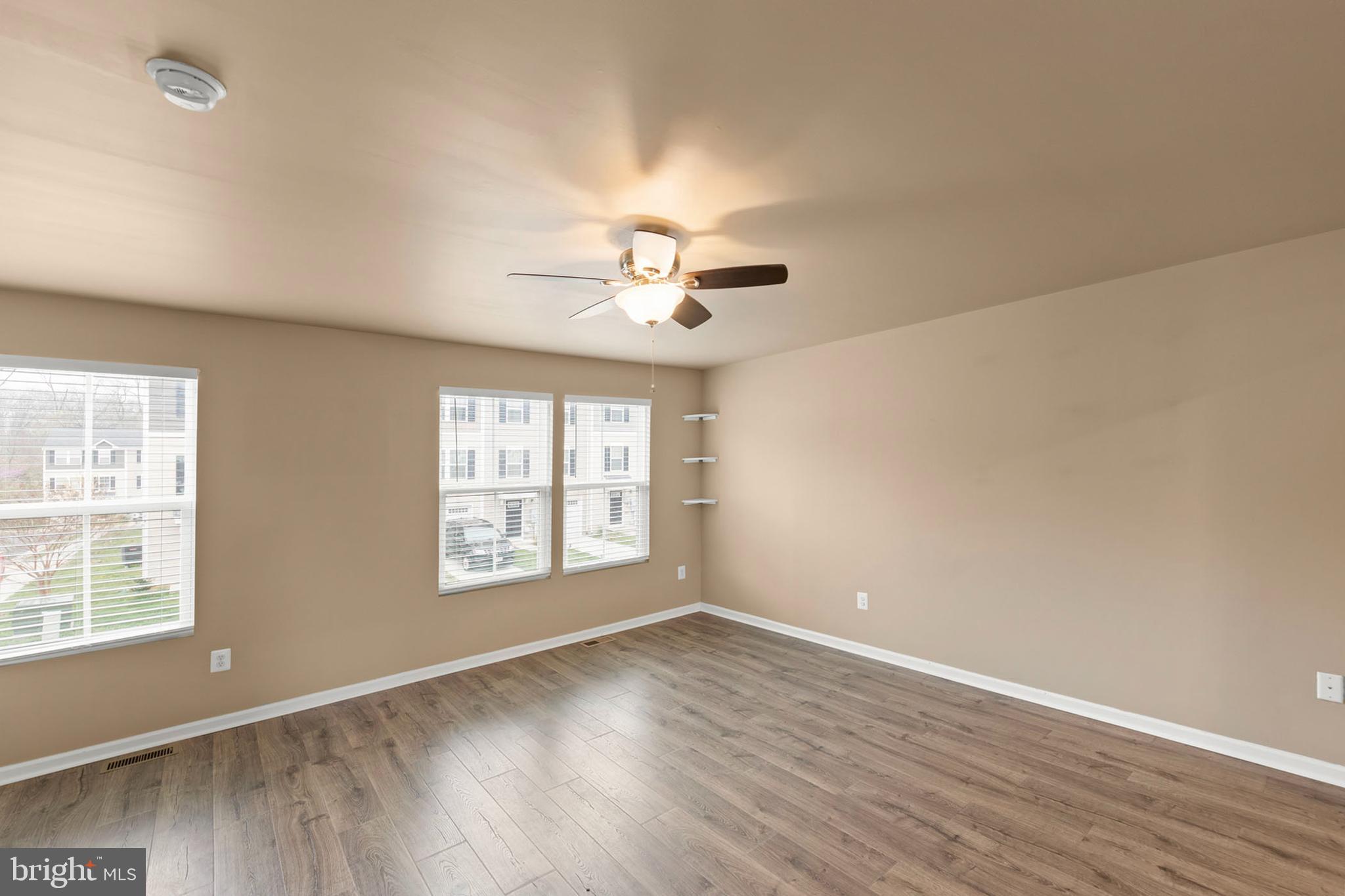 113 Reign Way Winchester, VA 22603 - Photo 13 of 35 an empty room with wooden floor and windows