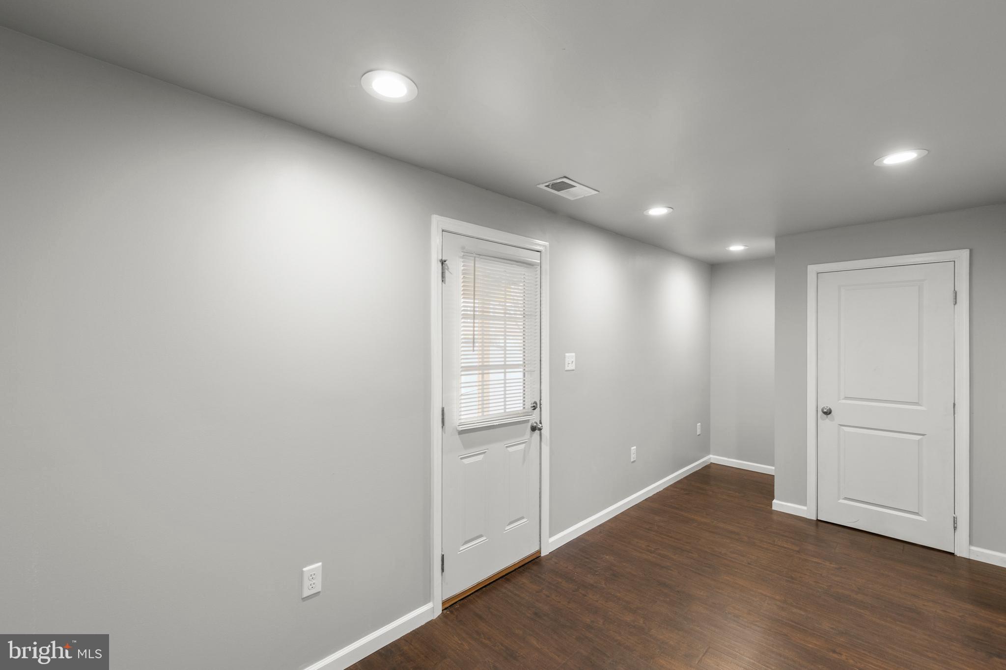 113 Reign Way Winchester, VA 22603 - Photo 28 of 35 an empty room with wooden floor and windows