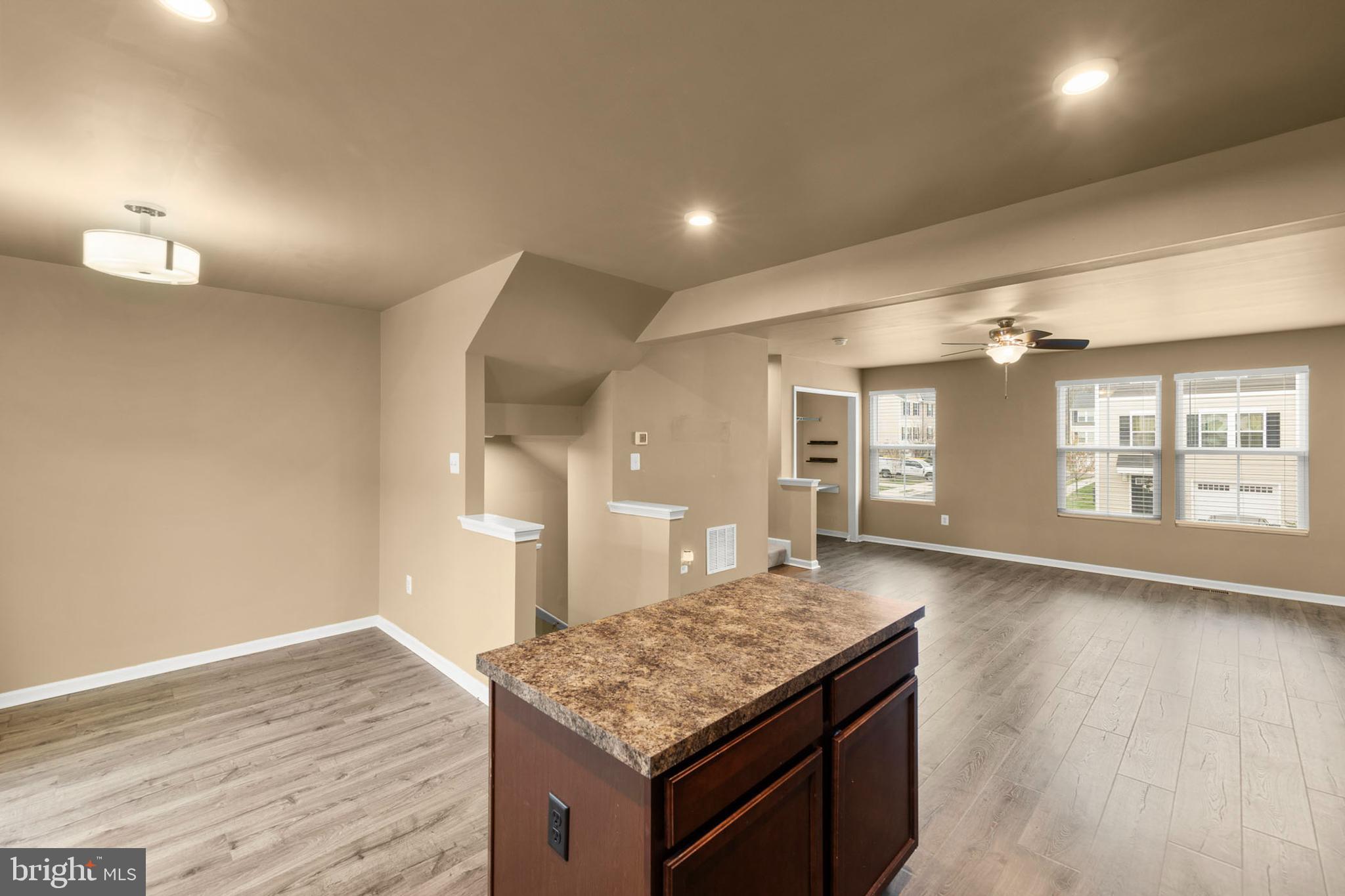 113 Reign Way Winchester, VA 22603 - Photo 3 of 35 a kitchen with a stove and a wooden floor