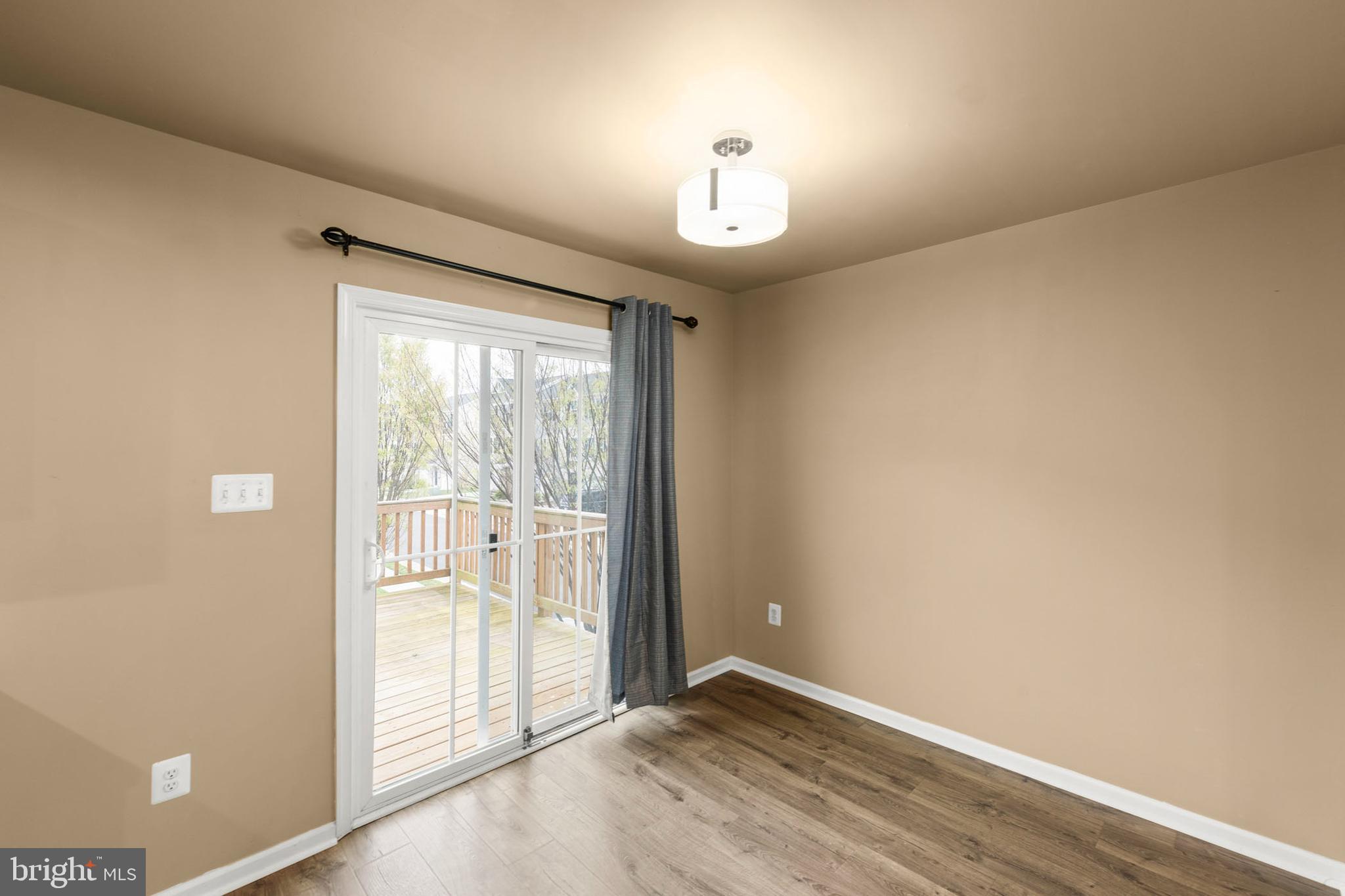 113 Reign Way Winchester, VA 22603 - Photo 7 of 35 an empty room with wooden floor and windows